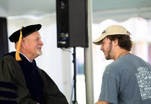 New student shaking hands with Interim President Dr. Jim Dlugos during the Fall 2024 convocation ceremony